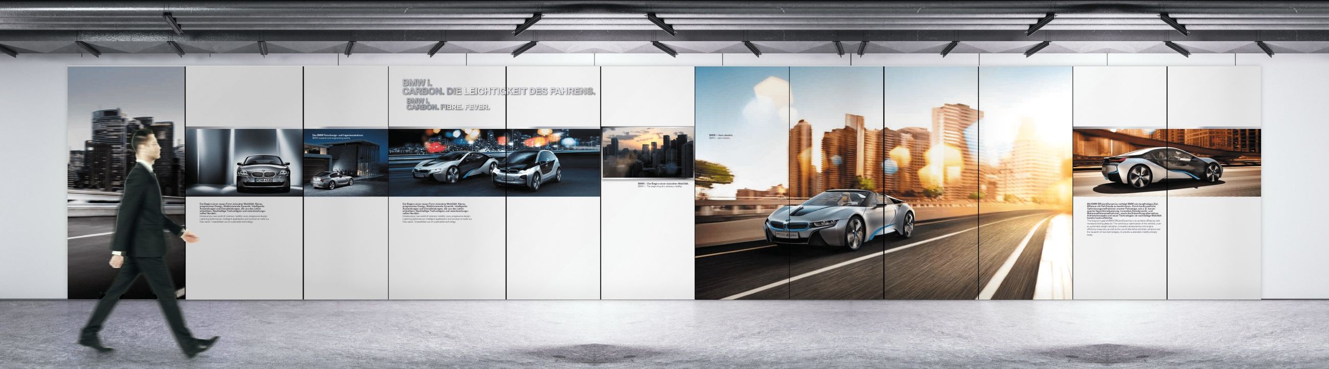 Wandgestaltung für BMW i in voller Länge, ein Mann geht vorbei
